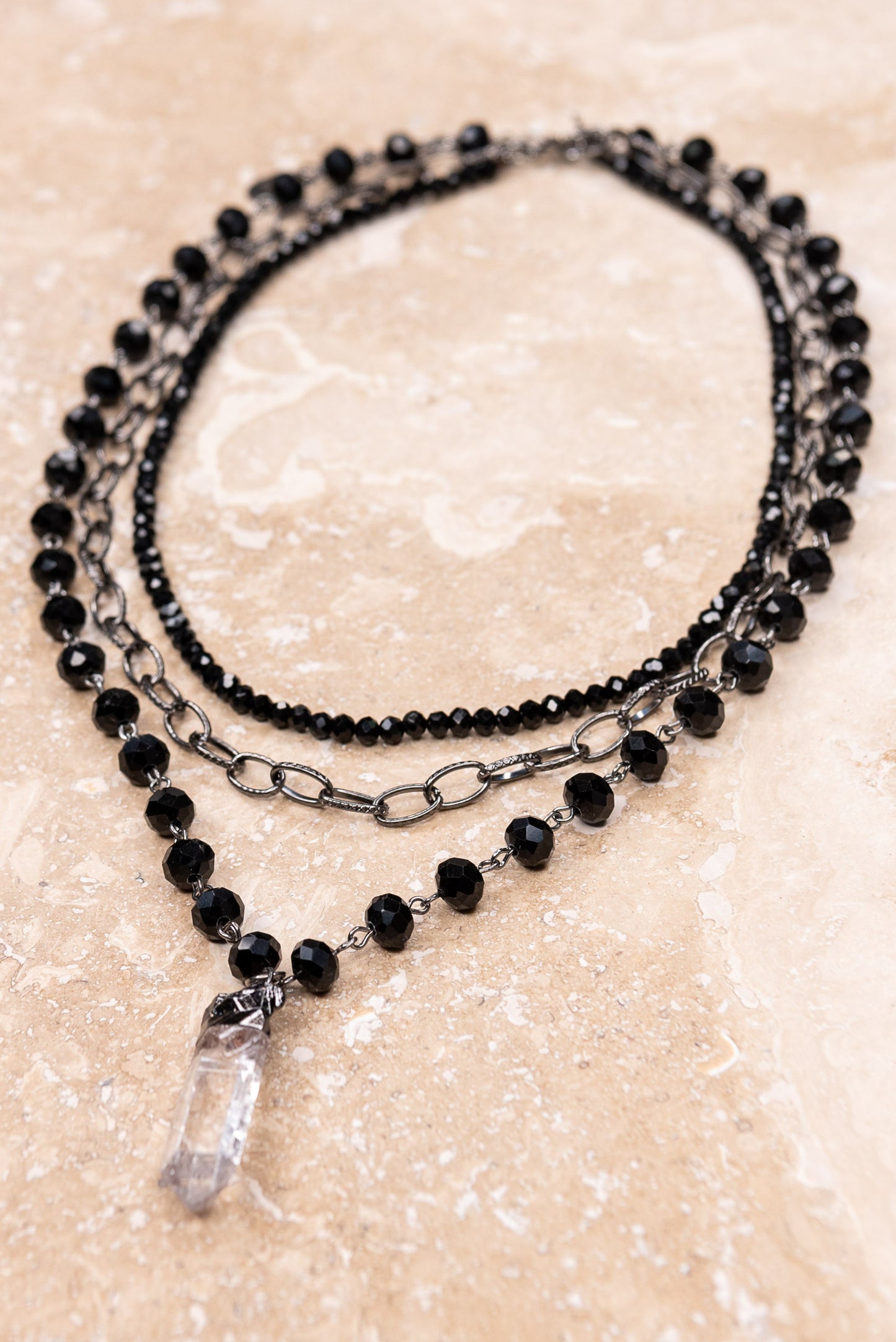 Triple layer black necklace with crystal pendant