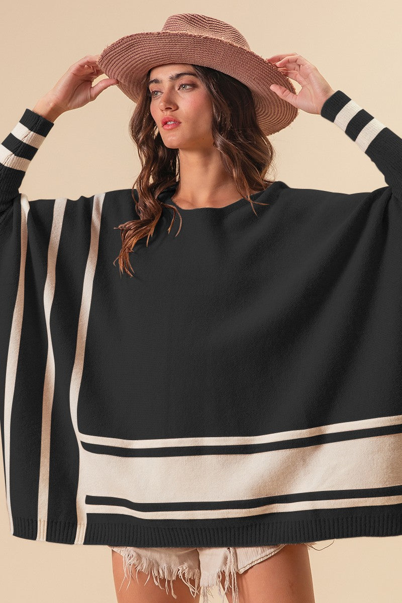 Black poncho like sweater with ivory trim detail